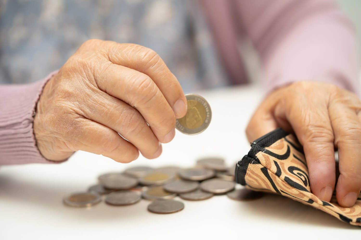 starsza kobieta licząca oszczędności ze średniej emerytury w Polsce